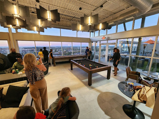 Inside view of an apartment building's common area and people socializing.