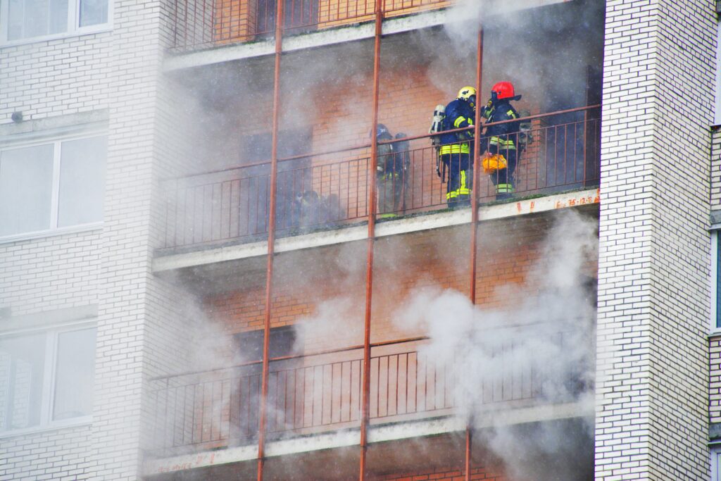 Firefighters working to extinguish a building fire, emphasizing the importance of restoring air quality after a fire.